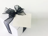 Gift box of cookies. Sugar cookie swirled with chocolate in white box with black bow. Classic cookie gift.