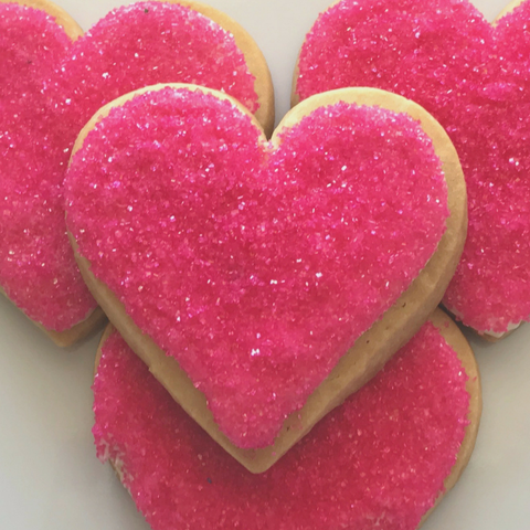 Pink heart shaped sugar cookies guittard white chocolate and pink sprinkles gift wrapped