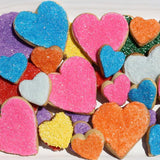 Heart shaped sugar cookies with rainbow colored sprinkles.