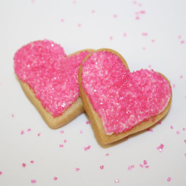 Heart shaped cookies pink sprinkles. Sugar cookies with pink sprinkles