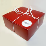 Red gift box packed with cookies and personalized note