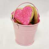 pink heart shaped sugar cookie favors in pink bucket